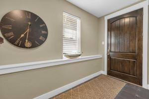 a large clock on the wall next to a window at Charming 3BR-Near Skiing & Hiking in Kamas