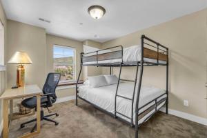 a bedroom with two bunk beds and a desk at Charming 3BR-Near Skiing & Hiking in Kamas