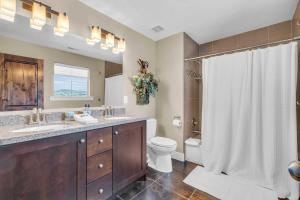 a bathroom with a sink and a toilet and a shower at Charming 3BR-Near Skiing & Hiking in Kamas +14 photos