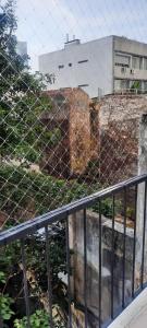 a wire fence with a building in the background at Hermoso departamento en Palermo muy luminoso in Buenos Aires