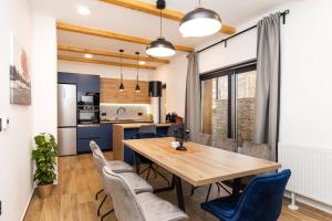 una sala da pranzo e una cucina con tavolo e sedie in legno di Luxury villa with a parking space Kupjak, Gorski kotar - 23067 a Kupjak