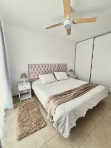 a bedroom with a large bed with a ceiling fan at El Girasol en Portales de Tupungato in Tupungato