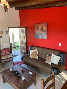a living room with a couch and a table at Casa MAAT Villa Serrana in Villa Serrana +1 photo