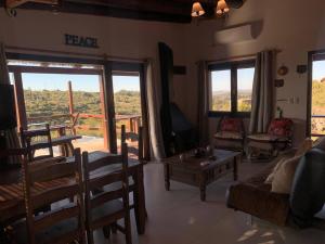 a living room with a couch and a table at Casa MAAT Villa Serrana in Villa Serrana