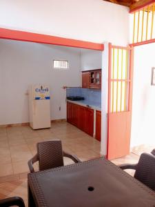 a kitchen with a table and chairs and a refrigerator at Casa Nohelia in Jericó