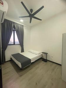 a bedroom with a bed and a ceiling fan at HARRAZ SUITE PUTRAJAYA just minutes away from PICC and KPT perfect for both business and leisure stays in Putrajaya