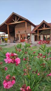 a house with pink flowers in front of it at Ayres del Golf Posada-Restó in Merlo +90 photos