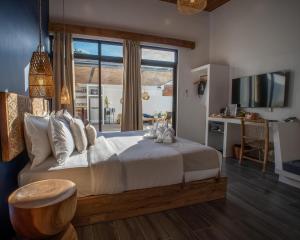 a bedroom with a large bed with a table and a desk at Villa Kasadya in Panglao