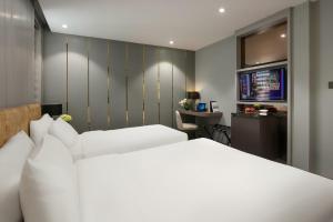 Voodi või voodid majutusasutuse Ping Hotel toas
