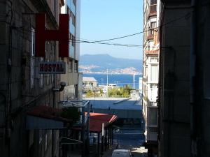 an alley with a view of the ocean from between buildings at Hostal Continental in Vigo