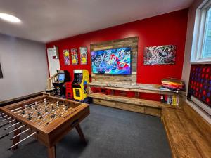 a living room with a table and agamuitous at Rustic Poconos Ranch w Game Room in Tobyhanna