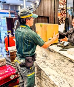 a man standing at a counter in a store at APA Hotel TKP Tokyo Nishi-Kasai in Tokyo
