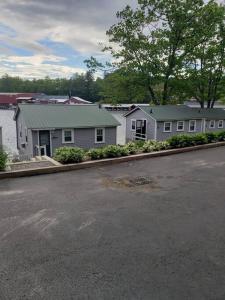 a house on the side of a road next to a street at Lakefront Cottage on Beautiful Lake Winnipesaukee in Laconia