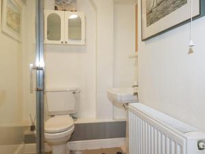 a small bathroom with a toilet and a sink at Langurra in Newquay +31 photos