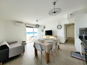 a living room with a table and a couch at Canet - Appartement T3 Neuf, Climatisé, 4 Pers, Parking inclus - FR-1-794-98 in Canet-en-Roussillon