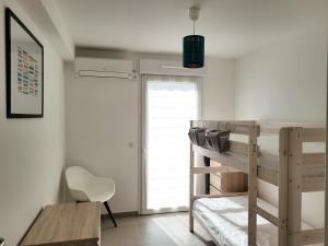 a bedroom with a bunk bed and a desk and a chair at Canet - Appartement T3 Neuf, Climatisé, 4 Pers, Parking inclus - FR-1-794-98 in Canet-en-Roussillon