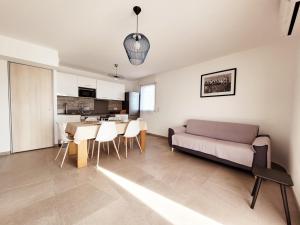 a living room with a couch and a table at Canet - Appartement T3 Neuf, Climatisé, 4 Pers, Parking inclus - FR-1-794-98 in Canet-en-Roussillon