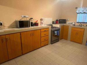 a kitchen with a microwave and a stove top oven at Casa Mariano Matamoros in Matamoros