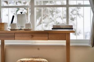 a wooden table with a window in a room at Togari Inn Suites in Iiyama +133 photos