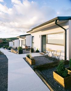 a patio of a house with tables and chairs at VILLACHANCLETA in Tagle