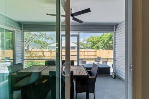 a dining room with a table and a ceiling fan at Stunning Beachfront Duplex! in Saint Augustine