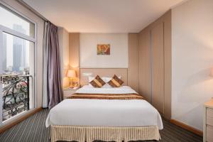 Postel nebo postele na pokoji v ubytování Super Candle Hotel