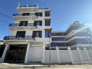 a white building with a fence in front of it at Hotel Lal's Inn in Kargil +17 photos