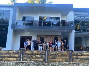 a group of people standing in front of a house at Altavista Resthouse in Altavista