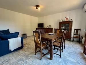 un salon avec une table et des chaises en bois dans l'établissement Maison 3 pièces avec jardin, à 2 pas du centre, 8 couchages, parking, clim et ménage inclus - FR-1-226B-208, à Cavalaire-sur-Mer