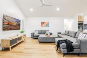 a living room with two couches and a table at Aquatic Abode in Agnes Water
