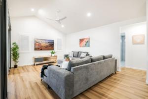 a living room with a couch and a table at Aquatic Abode in Agnes Water