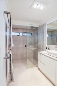 a bathroom with a shower and a sink at Aquatic Abode in Agnes Water