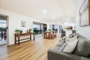a living room with a couch and a table at Aquatic Abode in Agnes Water