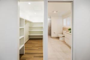 a bathroom with a toilet and a walk in closet at Aquatic Abode in Agnes Water
