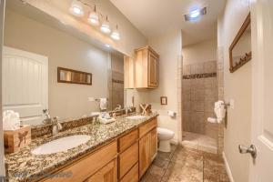 a bathroom with two sinks and a toilet and a shower at Cowboy Lodge RR94404 #4 in Canyon Lake +30 photos