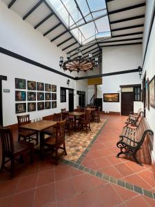 a dining room with wooden tables and chairs at Hotel Boutique San Antonio in Cali