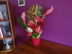 萊斯三河－勒茨的住宿－La Villa Des Tropiques - Turquoise，粉红色的花瓶,花朵放在桌子上