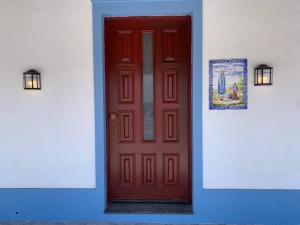 a red door on the side of a building at Oceanview Sunset Retreat in Pilar