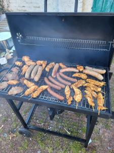 a grill with sausages and other food on it at Top Apartment Nähe Geilenkirchen, Heinberg und Übach Palenberg 90qm für 6 Personen in Geilenkirchen