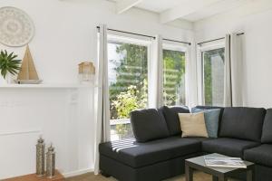 a living room with a couch and a window at Mysa Anglesea Sleeps 7 WiFi SmartTV Cafes Shops in Anglesea