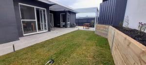 a backyard of a house with a fence at Mysa Anglesea Sleeps 7 WiFi SmartTV Cafes Shops in Anglesea
