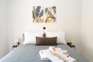 a bedroom with a bed with two white socks on it at Benessere in Chania Town