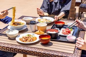 a group of people sitting around a table eating food at Tokyu Stay Tsukiji - Tokyo Ginza Area in Tokyo