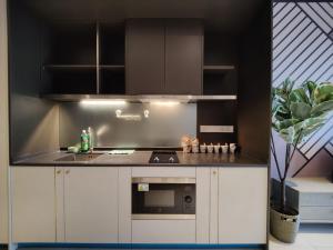a kitchen with white cabinets and a stove top oven at Millerz Square Old Klang Road in Kuala Lumpur +94 photos