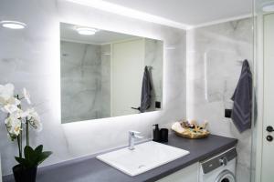 a bathroom with a sink and a mirror at Benessere in Chania Town +30 photos