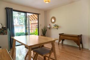 ein Esszimmer mit einem Holztisch und einem Schreibtisch in der Unterkunft Leeloo Paradise in Khanom