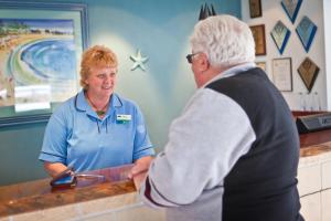 a man and a woman standing at a counter at BIG4 Middleton Beach Holiday Park in Albany