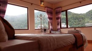 - une chambre avec un lit et une fenêtre donnant sur les montagnes dans l'établissement olivia Hotel, à Sa Pa 15 autres photos