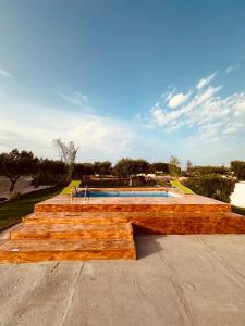 a wooden skateboard ramp in front of a swimming pool at Villa Santo Stefano in Monopoli