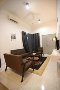 a living room with a couch and a table at Homestay Az Zikri D' Sepat in Kuantan